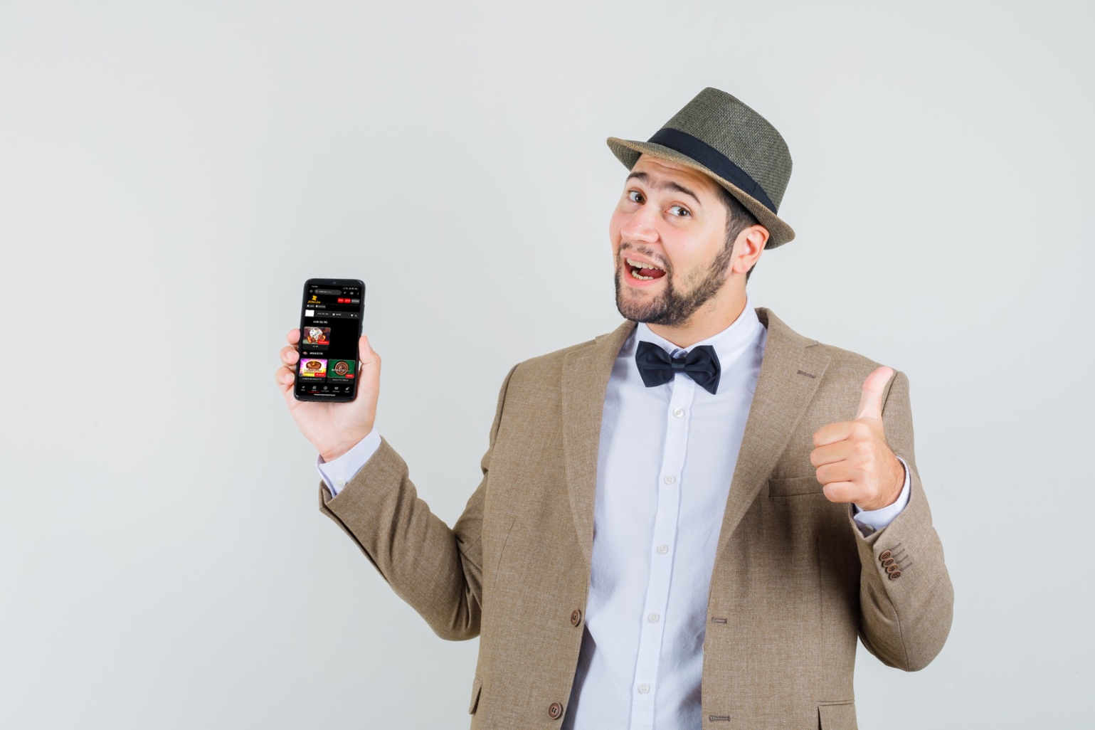 well-dressed man in a suit holds a smartphone showing gaming app