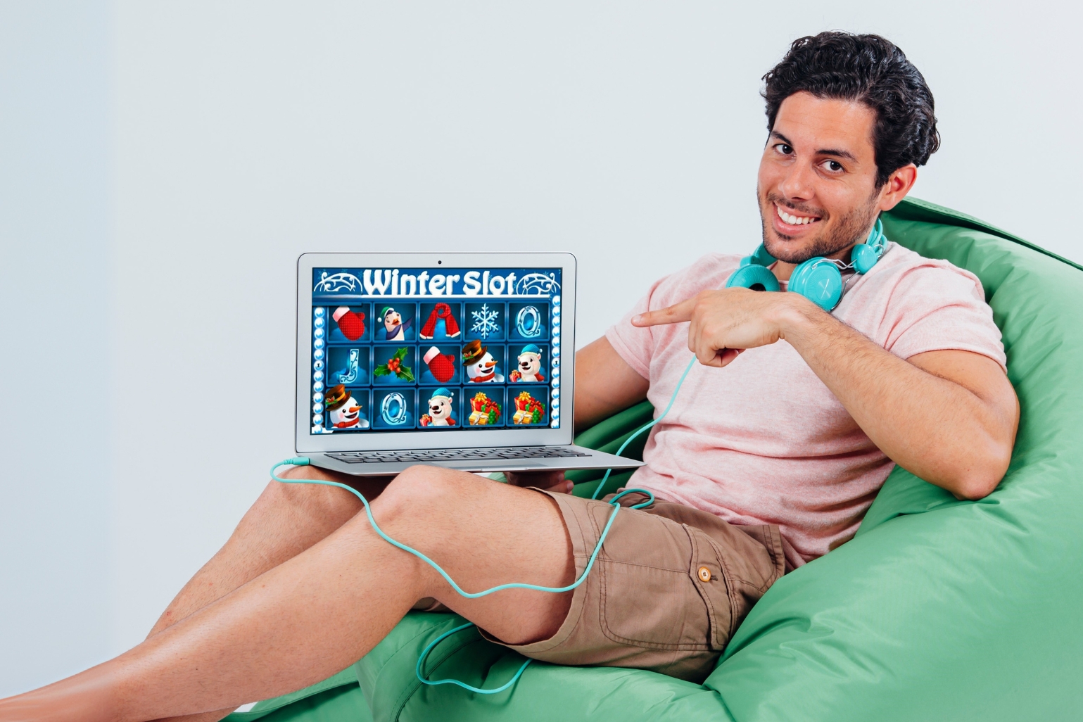 A man on a bean bag chair with a laptop, symbolizing online casino game shows